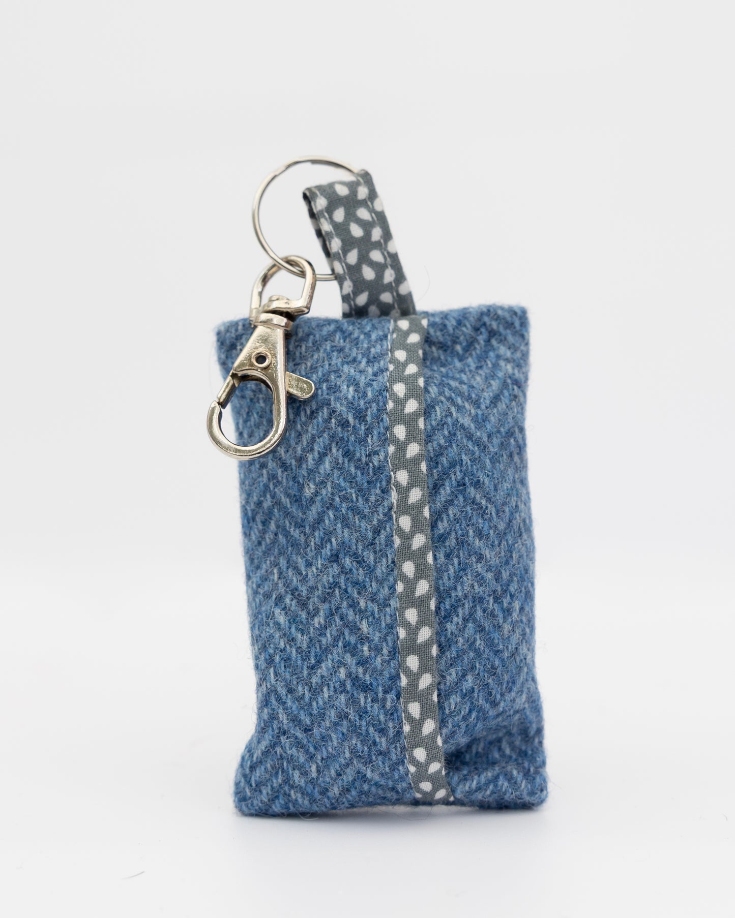 Blue fabric keychain pouch with a metal clasp on a white background
