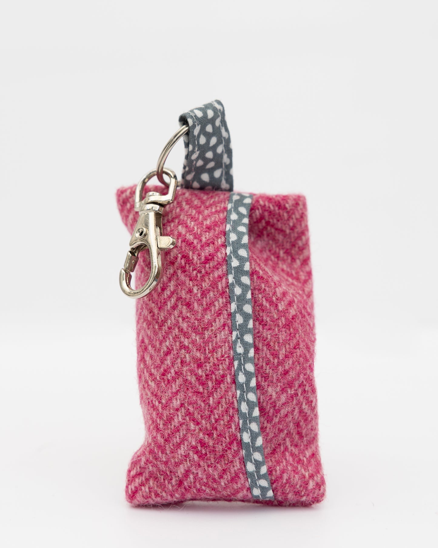 Pink fabric keychain with a metal clasp on a white background