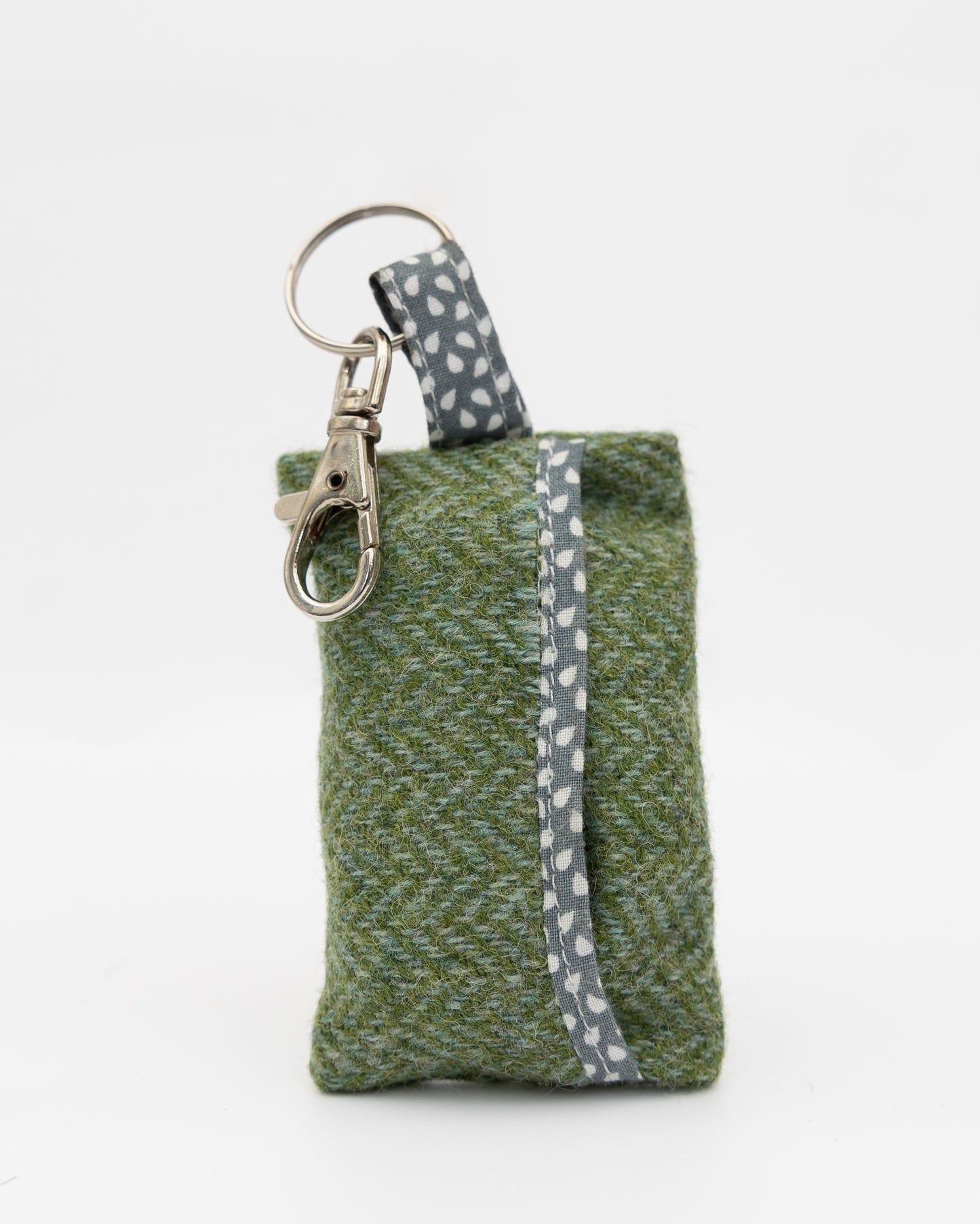 Green fabric keychain pouch with a gray strap on a white background