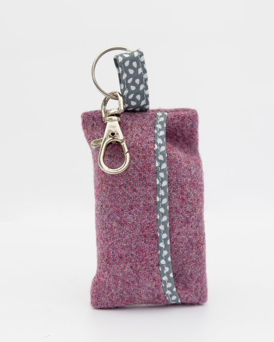 Purple fabric pouch with a keychain on a white background