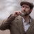 Man in tweed jacket and flat cap drinking from a Created By The Ridleys Harris Tweed Hip Flask outdoors