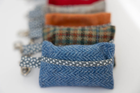 Set of colorful fabric pouches on a white background