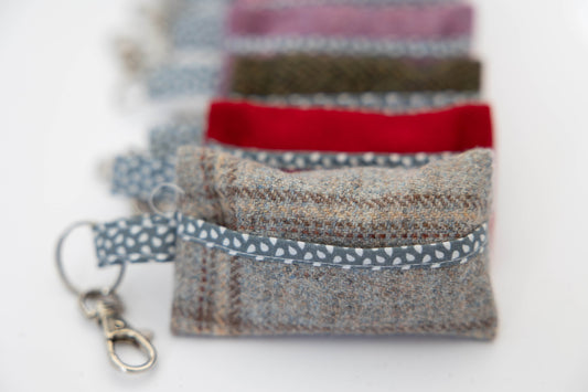 Set of fabric pouches with keychains on a white background