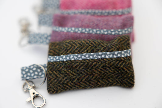 Fabric pouches with keychains on a white background