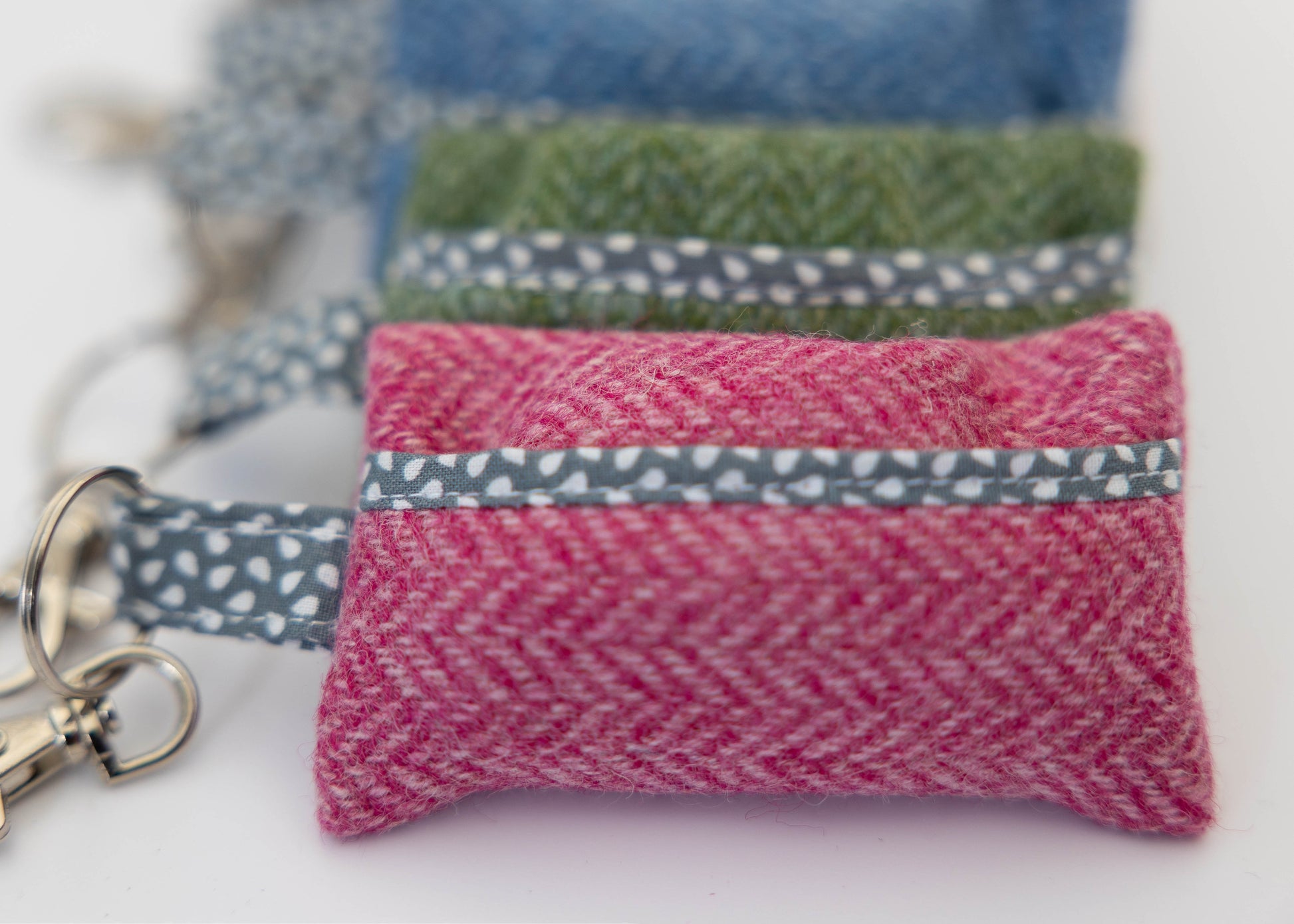 Set of fabric pouches with keychains on a white background