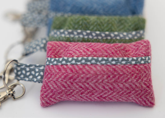 Set of fabric pouches with keychains on a white background