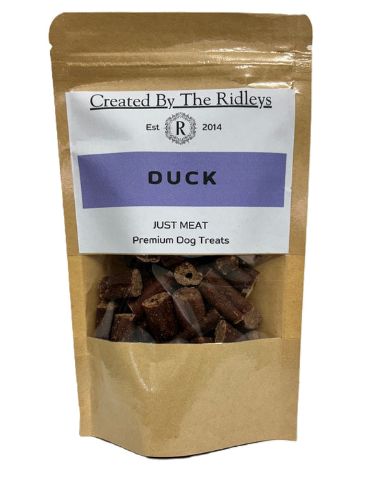 Bag of duck dog treats labeled 'Created By The Ridleys' on a white background