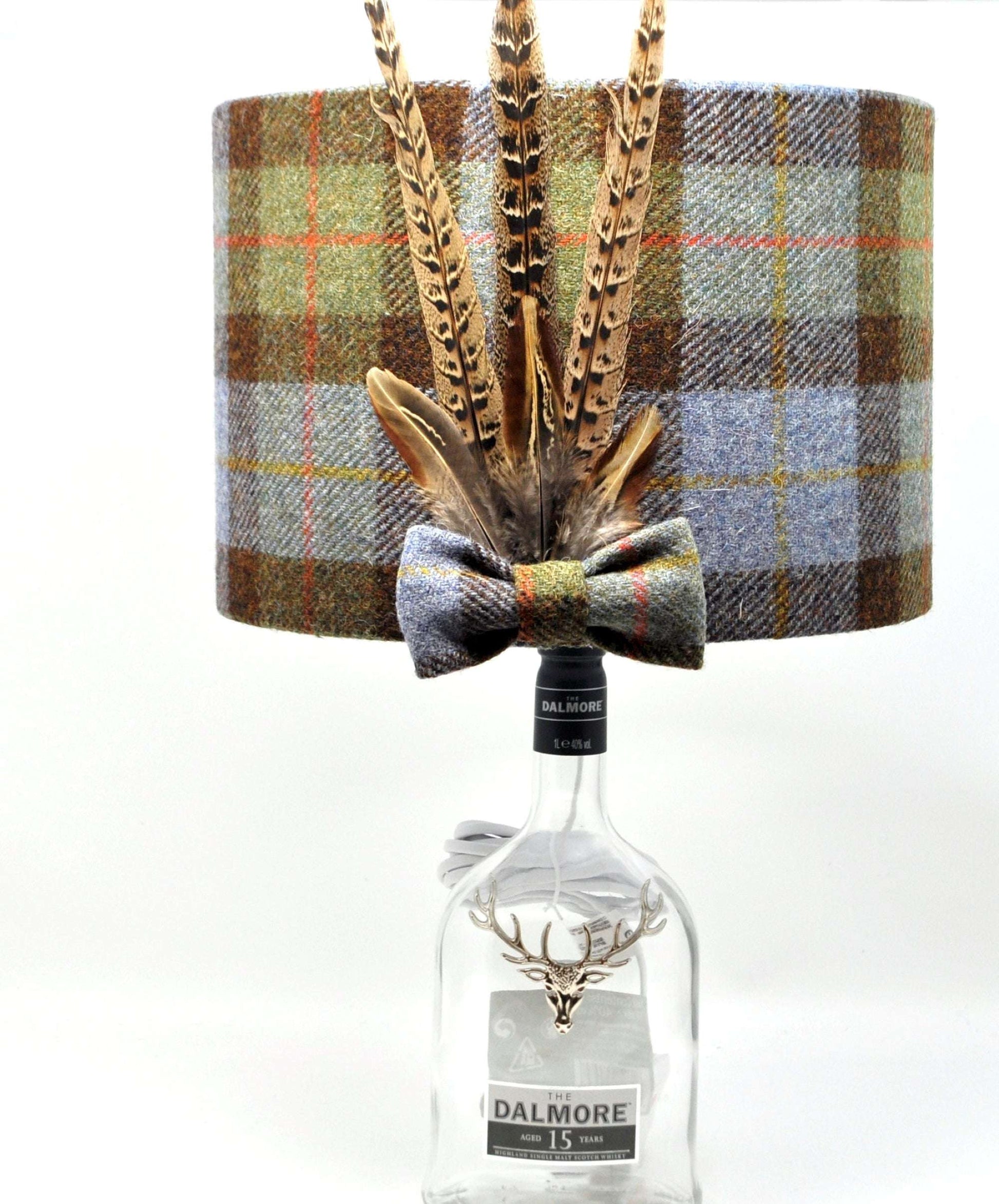 Stunning Harris Tweed lampshade featuring unique pheasant feathers, designed by Created By The Ridleys. Available in 20cm and 30cm sizes, this McLeod Tartan lampshade adds a touch of elegance to any space.
