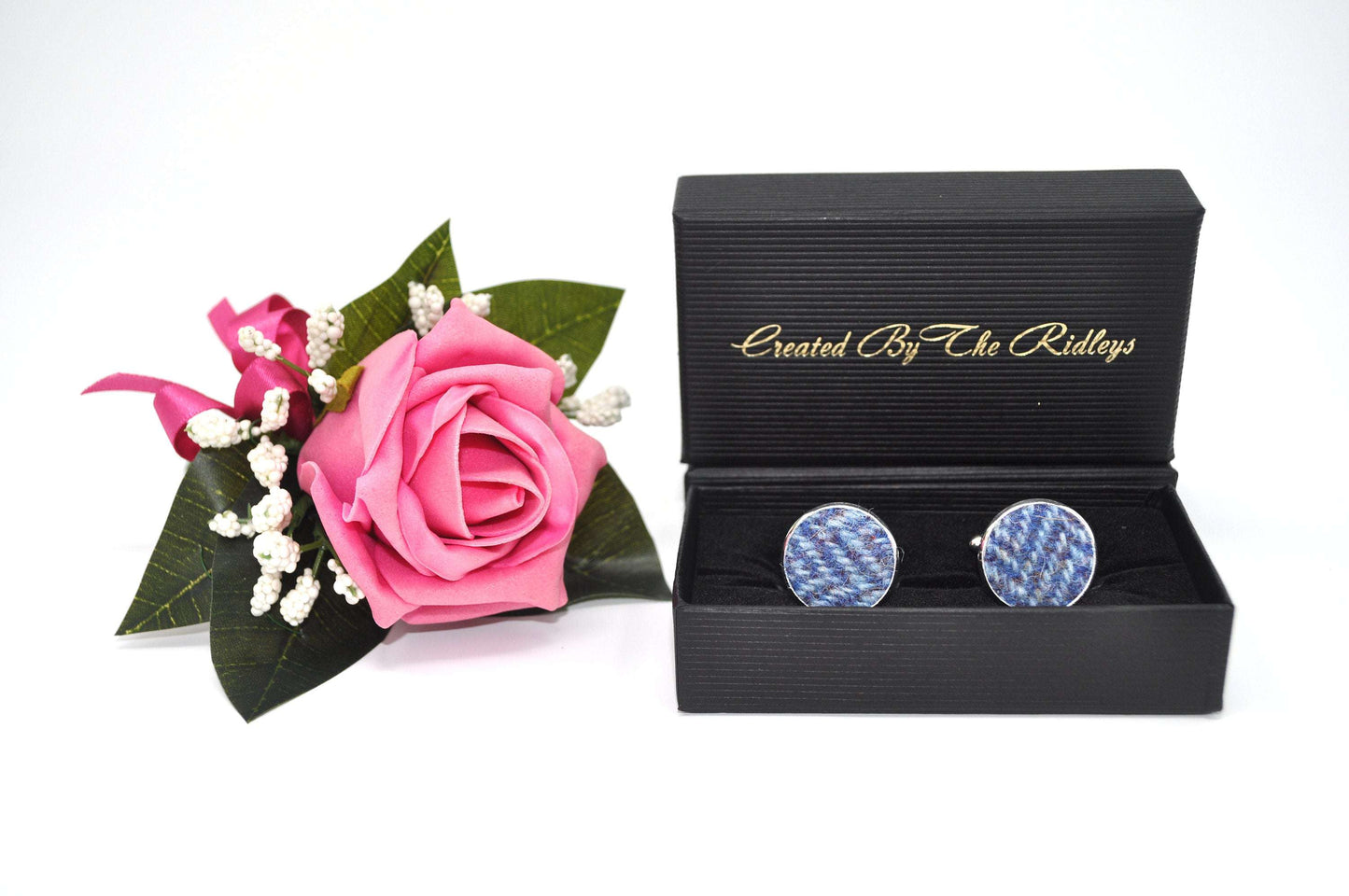 Blue tweed cufflinks in black gift box beside pink rose boutonniere, luxury handmade UK accessories