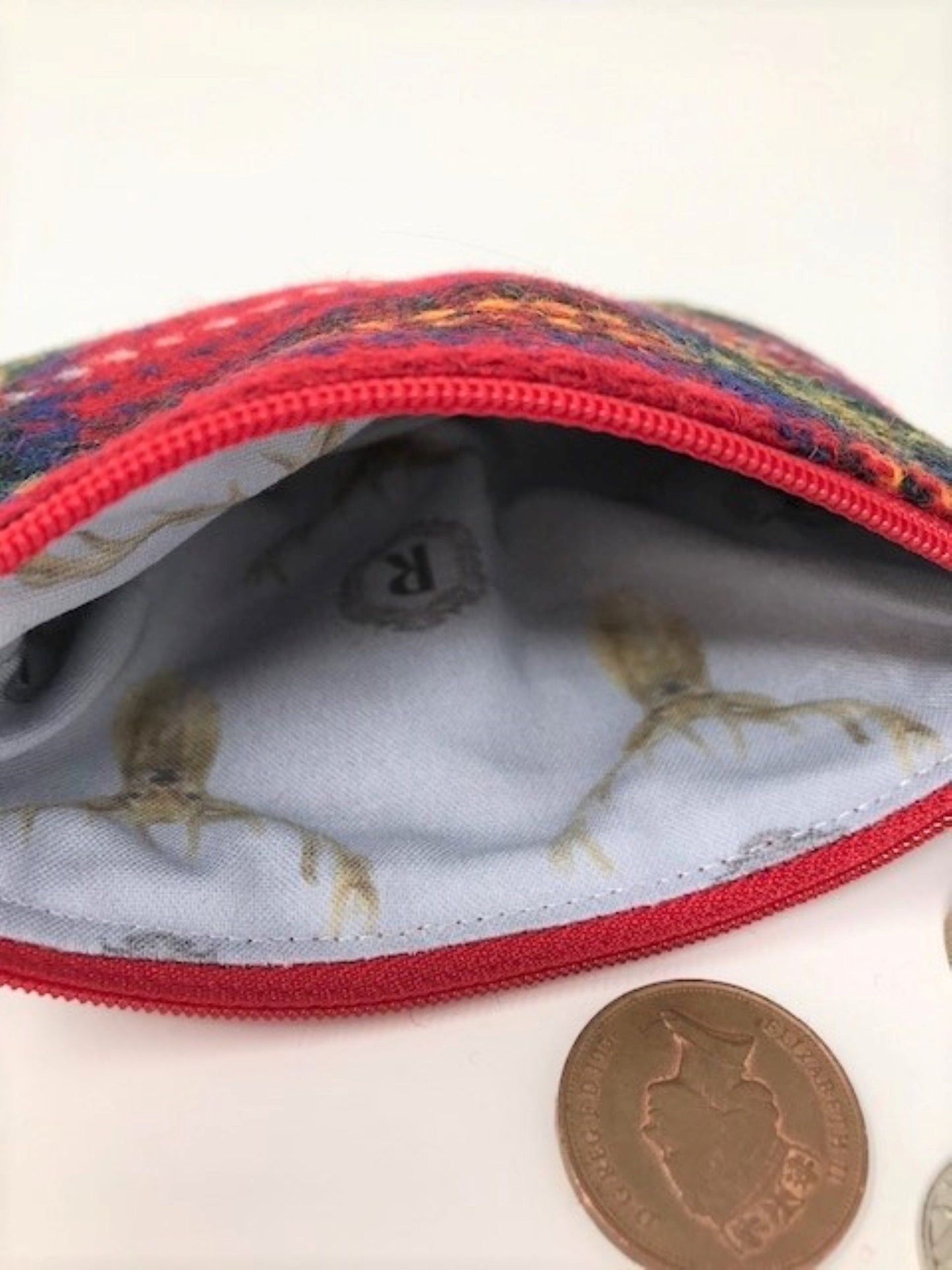 Handmade tweed coin purse with red zipper, deer-print lining, and UK coin for scale
